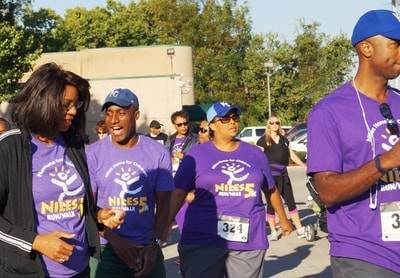 Attendees, including then councilperson Quinton Lucas and news anchor Cynthia Newsome, warming up before a Kansas City 5K Run/Walk fundraiser event, organized by Kelsey Haynes