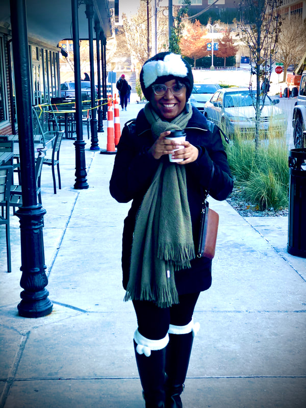 Chief content strategist, Kelsey Haynes, grabs coffee in the winter across from UMKC campus.